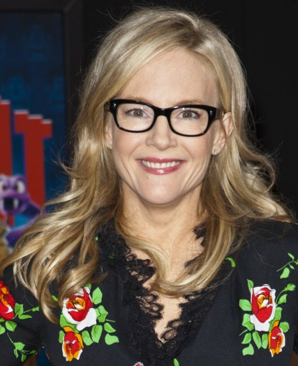 Rachael Harris | Black frame glasses and long hair with curled ends