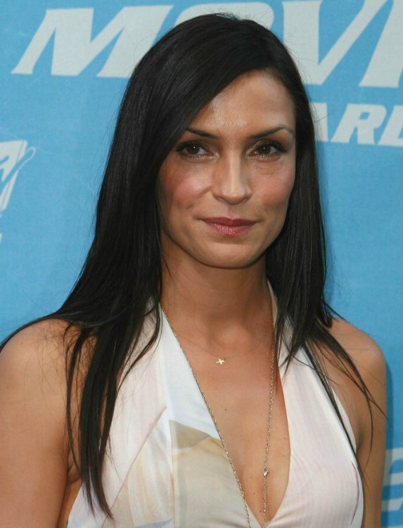 Famke Janssen with sleek long hair falling open around her 