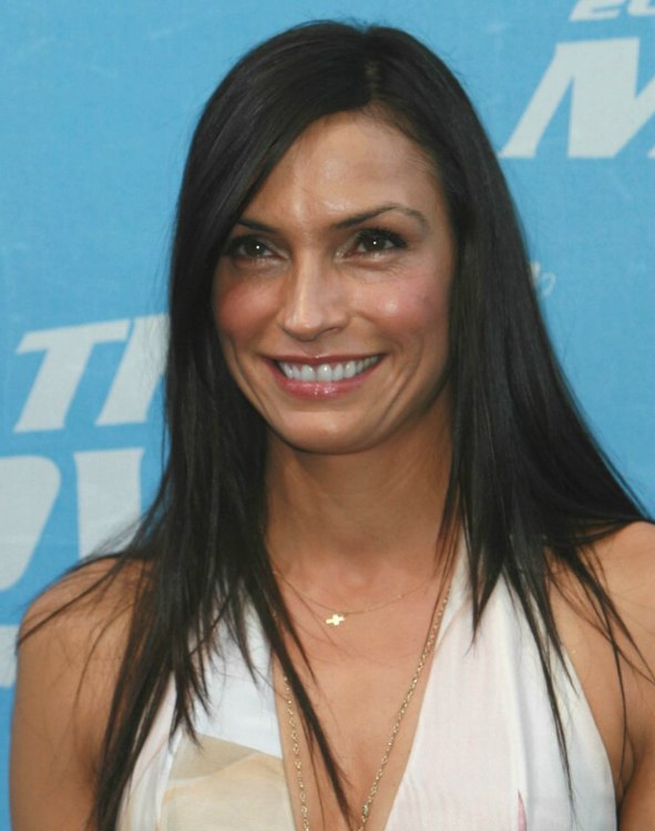 Famke Janssen with sleek long hair falling open around her 