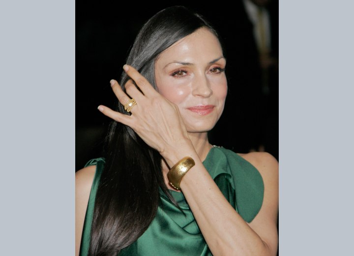Famke Janssen styling her straight hair with her hand