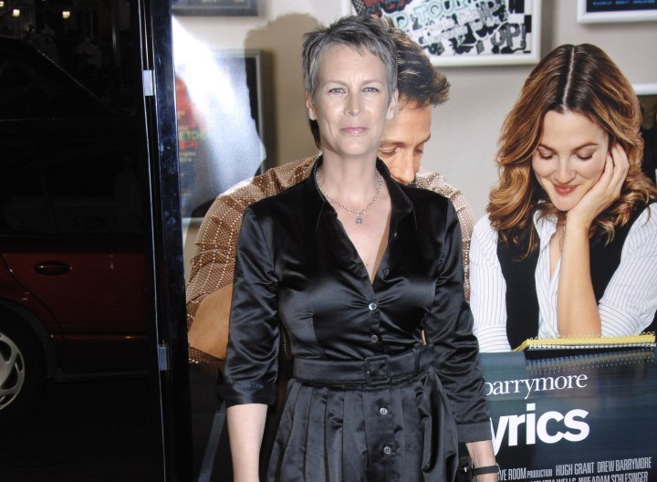 Jamie Lee Curtis wearing a black satin shirt dress