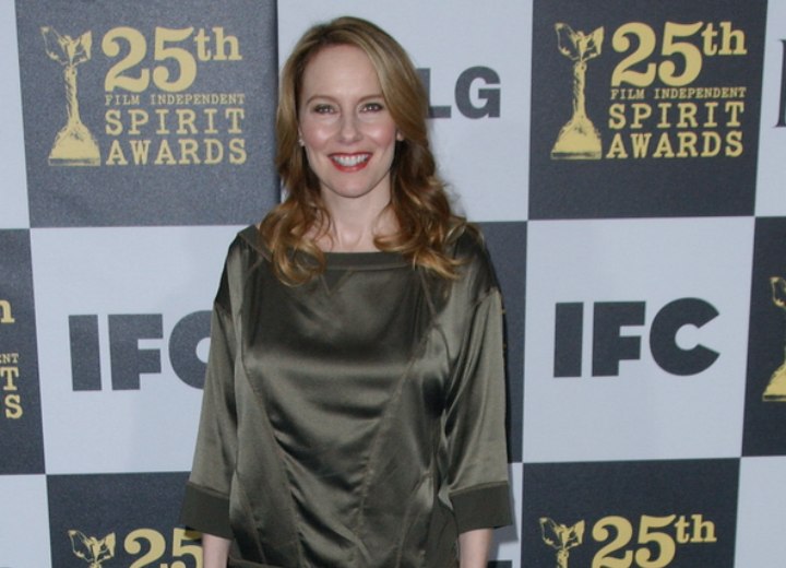 Amy Ryan wearing a shimmery green above the knees dress