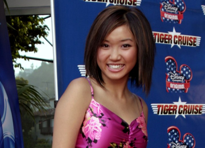 Brenda Song wearing a purple flower print dress