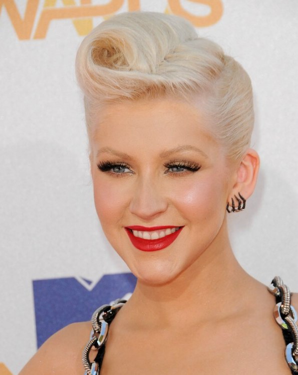 Christina Aguilera's hair smoothed back and sculptured into a French twist  | Pointy chin