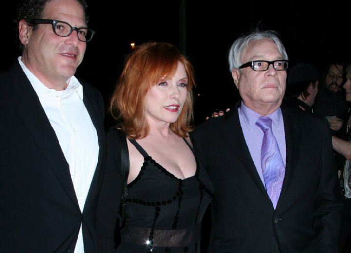 Debbie Harry with red hair and wearing a black dress