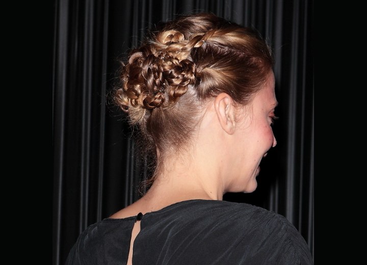 Estella Warren wearing her hair in an up-style with braiding