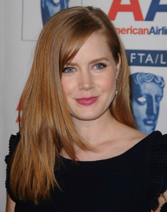 Amy Adams with her long reddish brown hair parted on the 