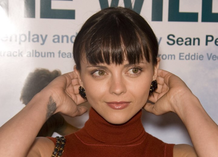 Christina Ricci tucking her hair behind her ears