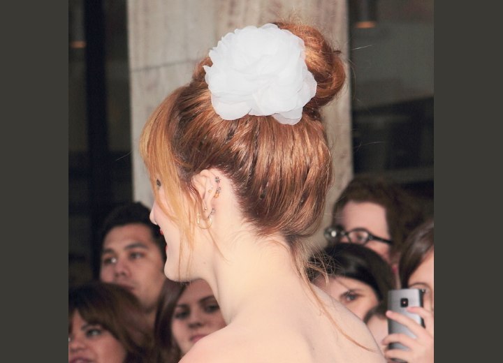 Bella Thorne wearing her hair in a ballerina style bun with a flower