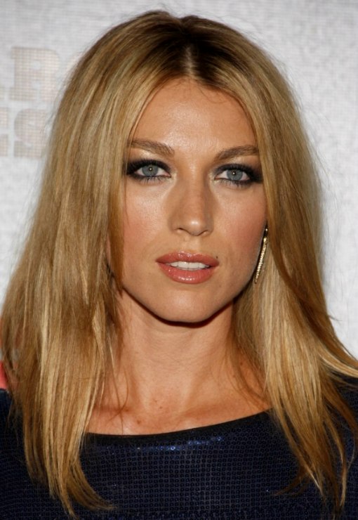 Natalie Zea with her long hair parted in the middle and 