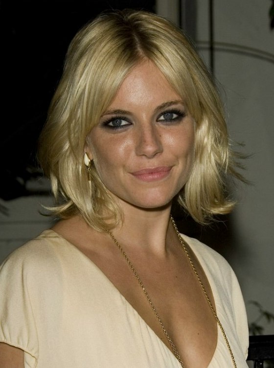 Sienna Miller with foiled blonde hair cut into a layered style