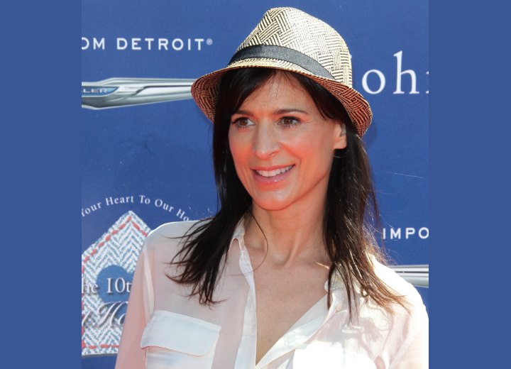 Perrey Reeves | Long brown hair, straw fedora hat and a soft sheer shirt