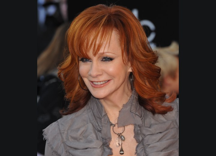 Long red hair with flipped out ends - Reba McEntire