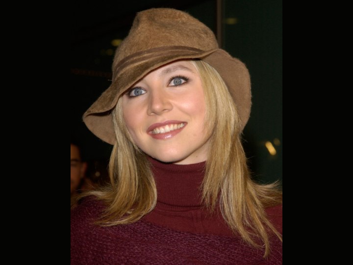 Sarah Chalke wearing a red turtleneck