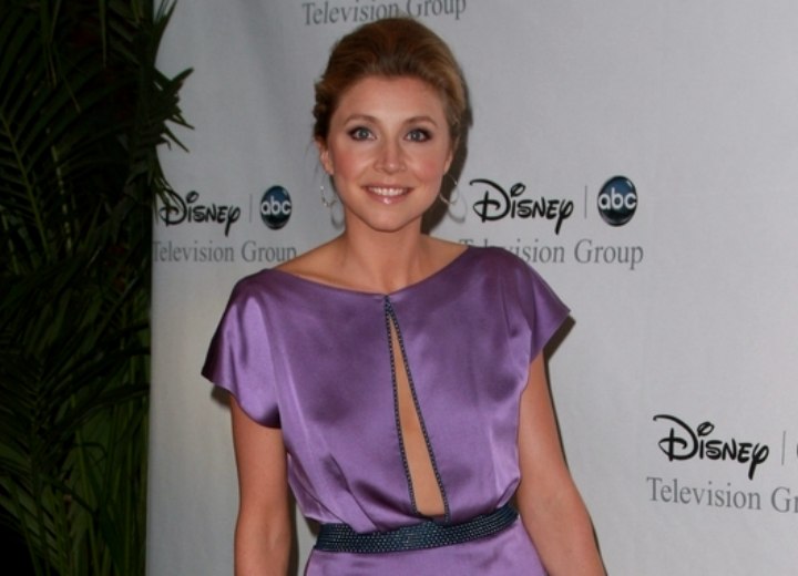 Sarah Chalke wearing a silky purple dress