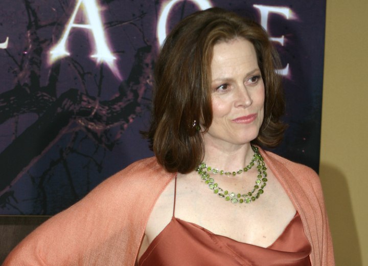Sigourney Weaver wearing an orange silk dress