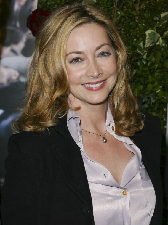 Sharon Lawrence wearing a silk shirt  Long hair with 