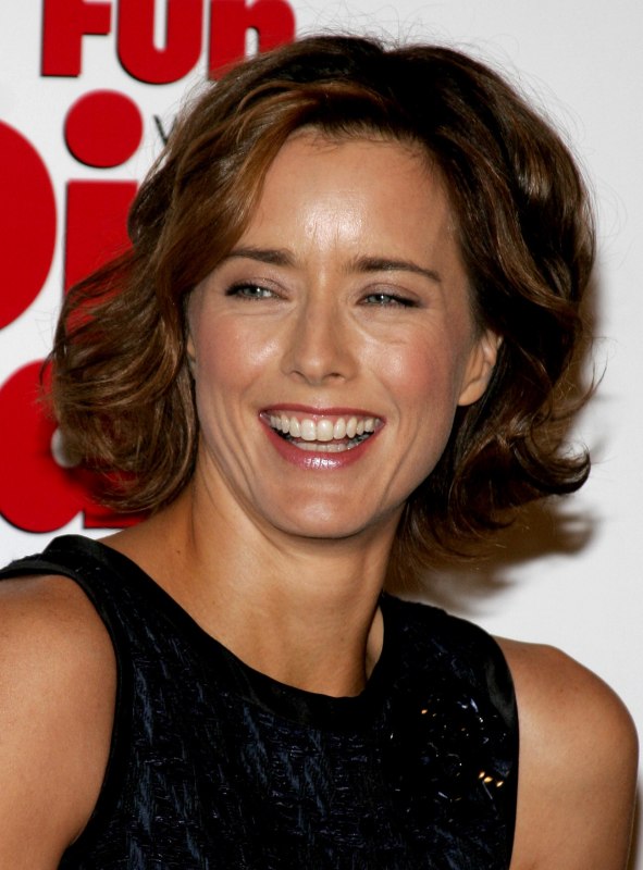 Tea Leoni wearing her hair short at chin length with curls