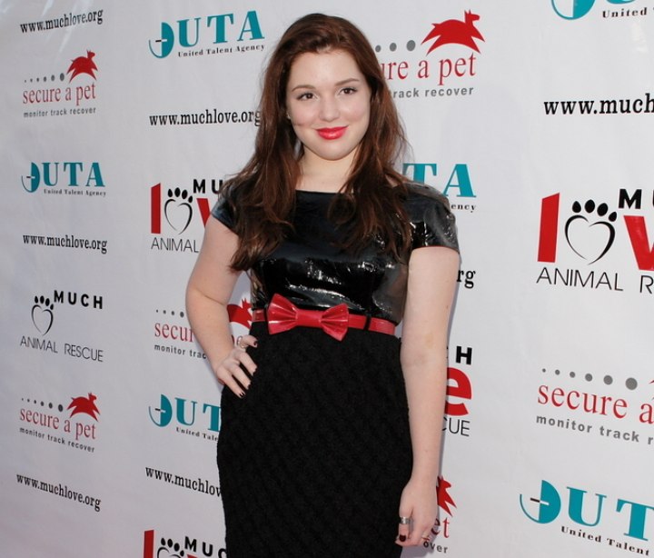 Jennifer Stone wearing a shiny black dress