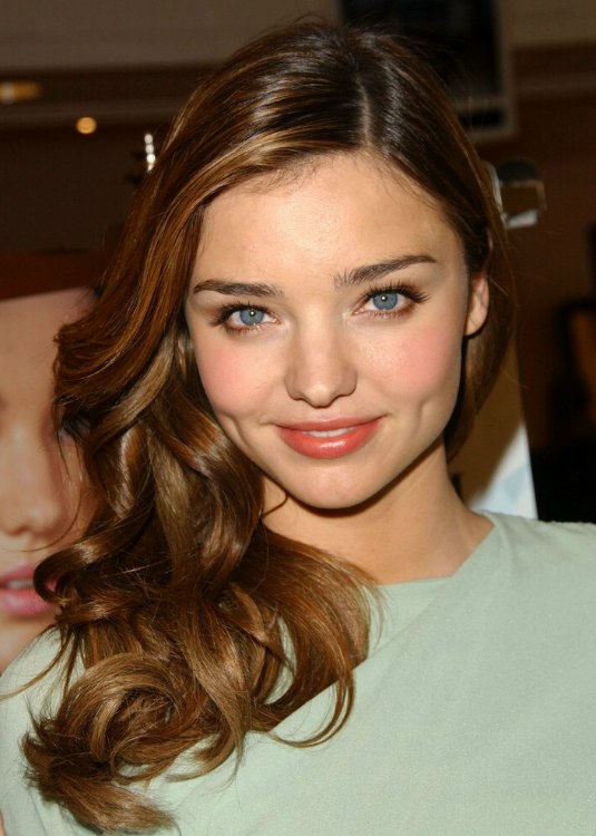 Miranda Kerr wearing her long hair with a straight part and curls