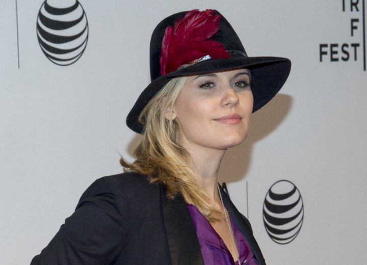 Maggie Grace with her hair past her shoulders and a hat