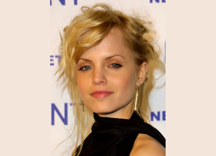 Mena Suvari wearing her hair up in a messy style