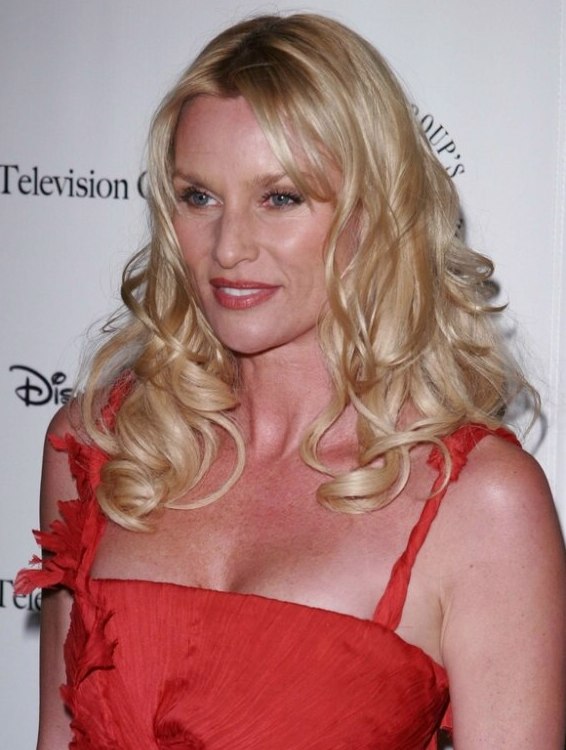 Nicollette Sheridan wearing her hair in long glossy curls 