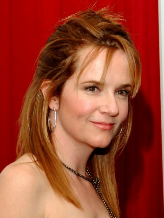 Lea Thompson wearing her hair partially up in the back and 