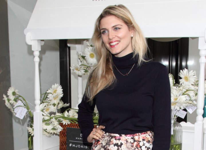 Ashley James wearing a skirt and turtleneck