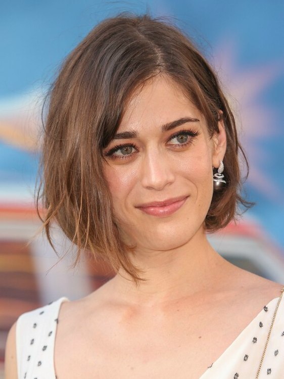 Lizzy Caplan's bob hairstyle with one side tucked behind the ear