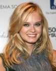 Sara Paxton's long hairstyle with a high part and curls
