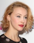 Sarah Gadon rocking a medium hairstyle with curls and waves