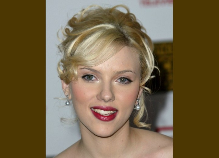 Scarlett Johannson with her hair in a curly romantic up style