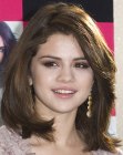 Selena Gomez wearing a mid-length hairstyle with round volume and added height