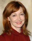 Sharon Lawrence wearing her auburn hair with long bangs and textured ends