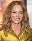 Sienna Guillory's long hairstyle with halfway curls