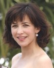 Sophie Marceau wearing her hair at mid-length and with choppy bangs