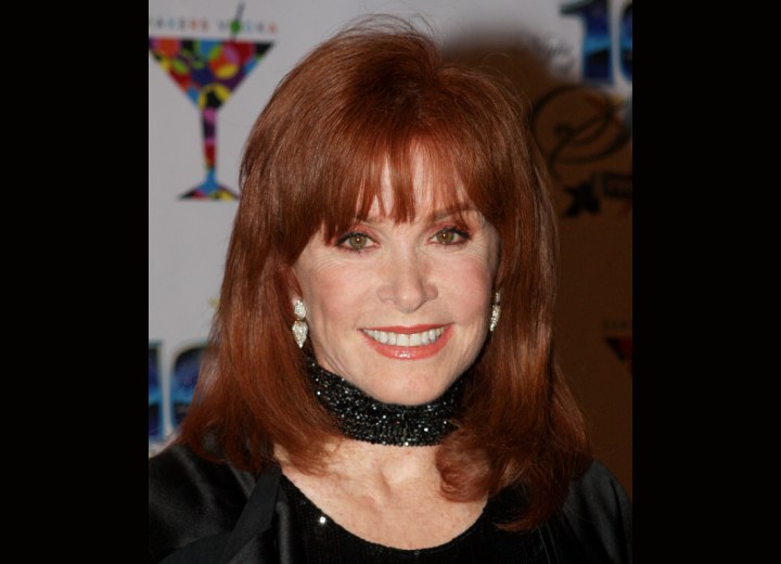 Stefanie Powers with red colored hair and spacey bangs