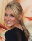 Stephanie Pratt with her long hair brought back and styled in a ponytail