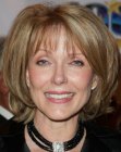 Susan Blakely's medium length hairdo with hair that flips up