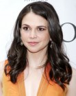Sutton Foster's long hairstyle with an angled part and bulky curls