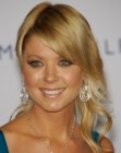 Tara Reid with her hair gathered into a low ponytail