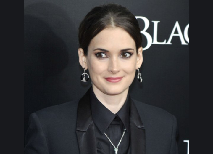 Winona Ryder wearing her hair pulled back into a knot