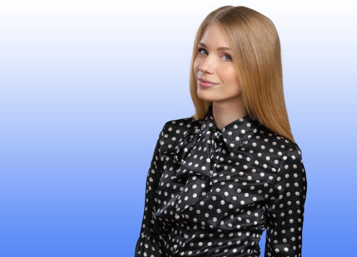 Woman with long hair wearing a silk polka dot blouse