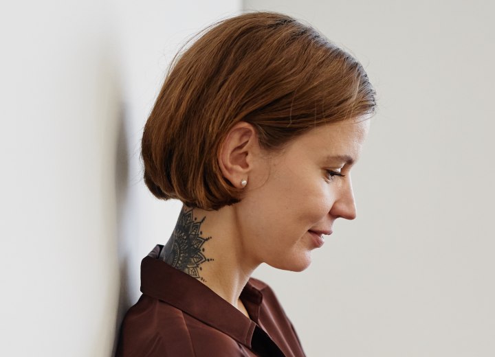 Woman with short hair and a tattoo in her neck