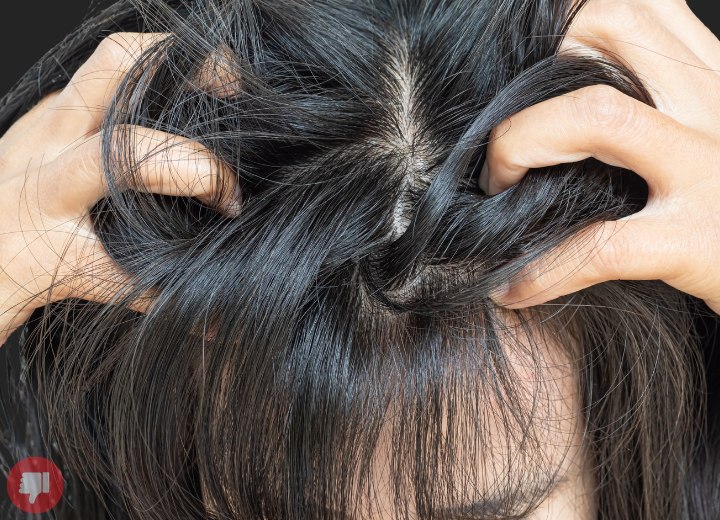 Woman scratching her head