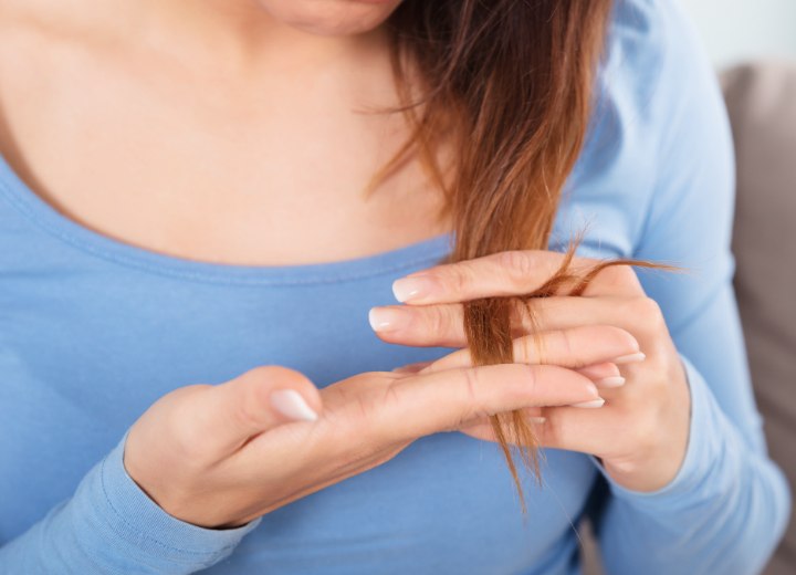 Girl who is checking her hair for split ends