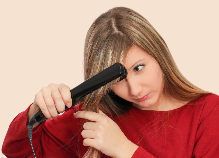Girl who is using a hair straightener