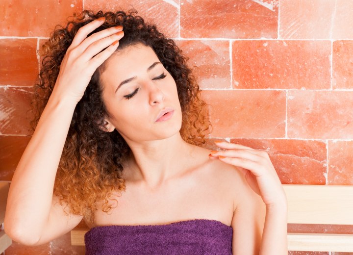 Woman with curly hair in a sauna