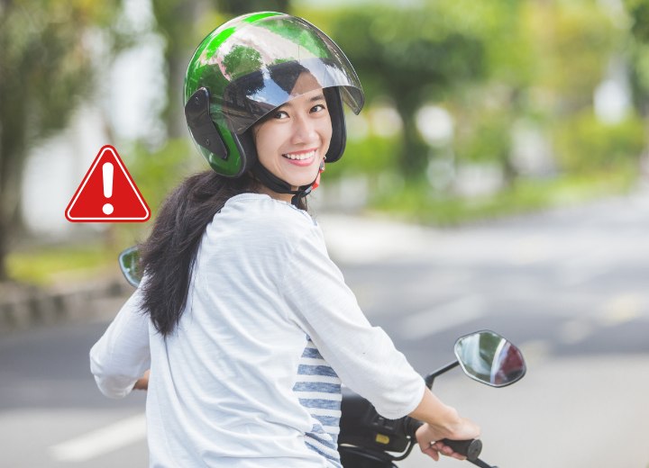 Woman with long hair, on a motorbike